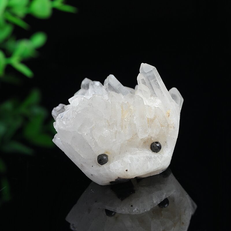 A natural white, shiny, clustered small hedgehog figurine carved from the original stone